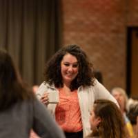 person standing with cup of coffee